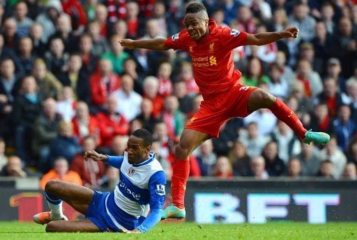 Liverpool's midfielder Raheem Sterling (R) scores against Reading